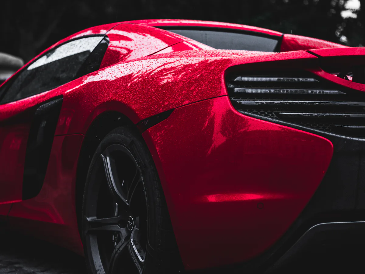 Glossy red paint with water beads after a wash