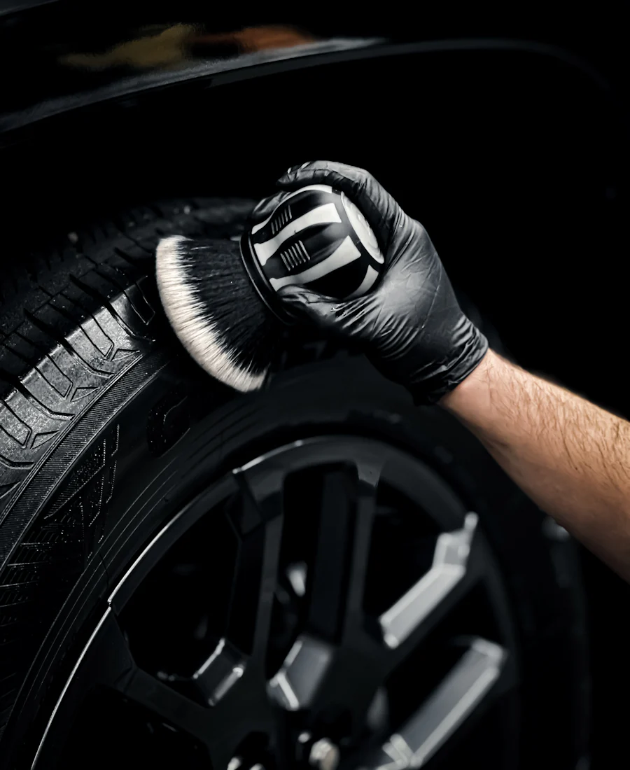A detailing brush cleaning a tire sidewall
